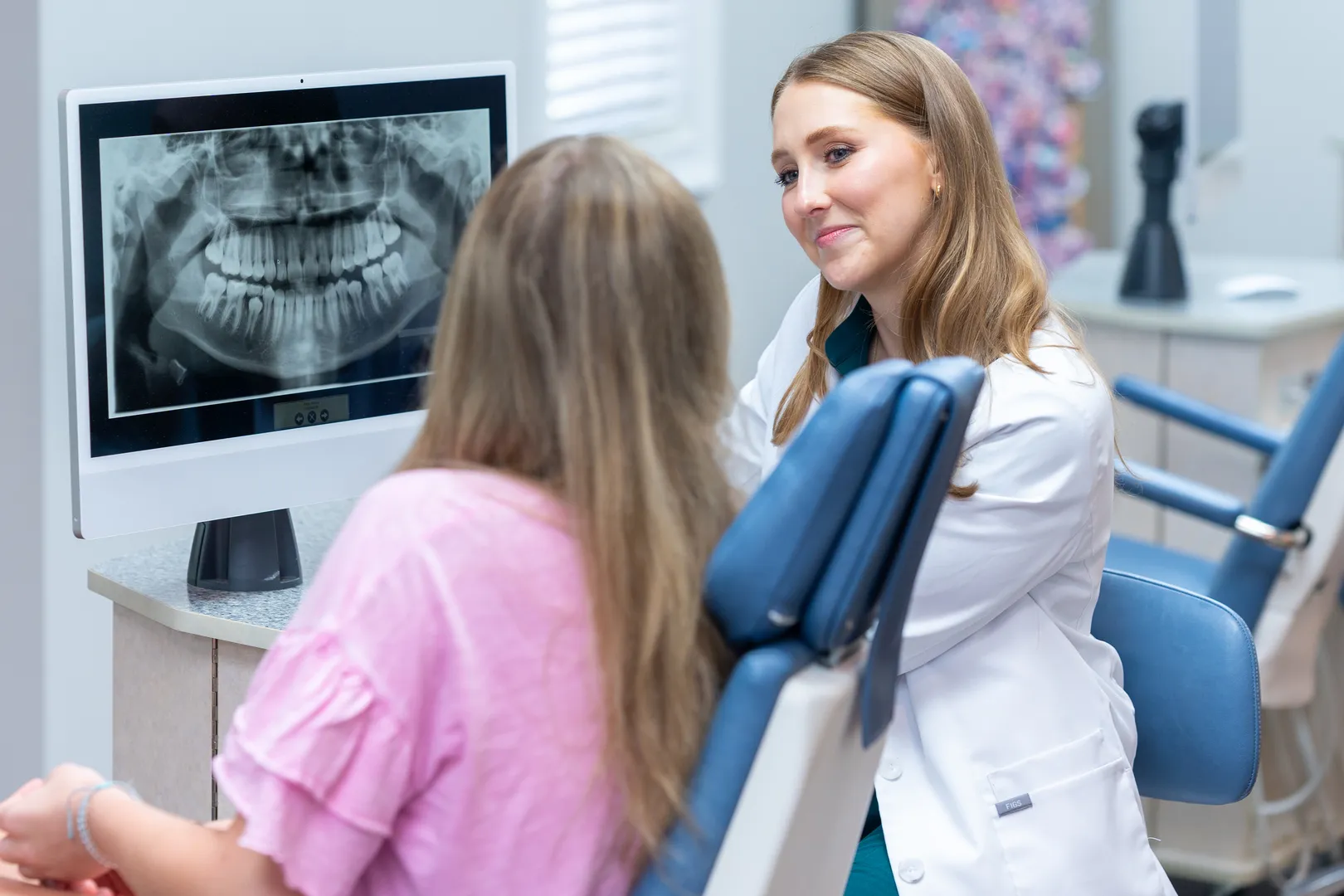 Dr. Brenna Reznik reviewing digital X-rays on screen with patient at West Cobb Orthodontics